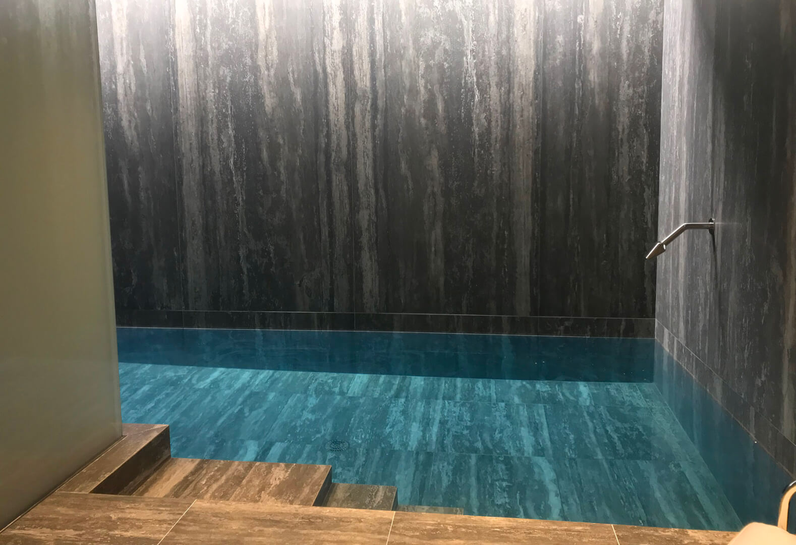 Tranquil indoor swimming pool with luxury neck massagers